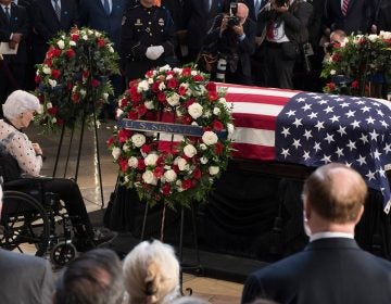 Roberta McCain, mother of John McCain, pays respects before his flag-draped casket Friday at the Capitol rotunda. His final public memorial is Saturday at the National Cathedral. (Jim Watson/AFP/Getty Images)