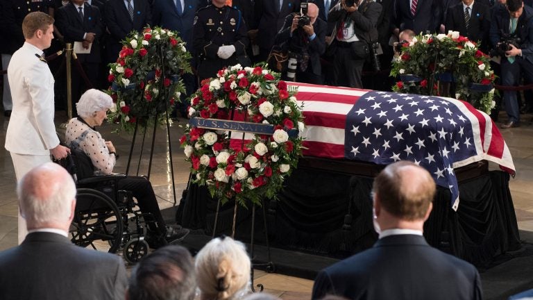 Roberta McCain, mother of John McCain, pays respects before his flag-draped casket Friday at the Capitol rotunda. His final public memorial is Saturday at the National Cathedral. Roberta McCain, mother of John McCain, pays respects before his flag-draped casket Friday at the Capitol rotunda. His final public memorial is Saturday at the National Cathedral. (Jim Watson/AFP/Getty Images)