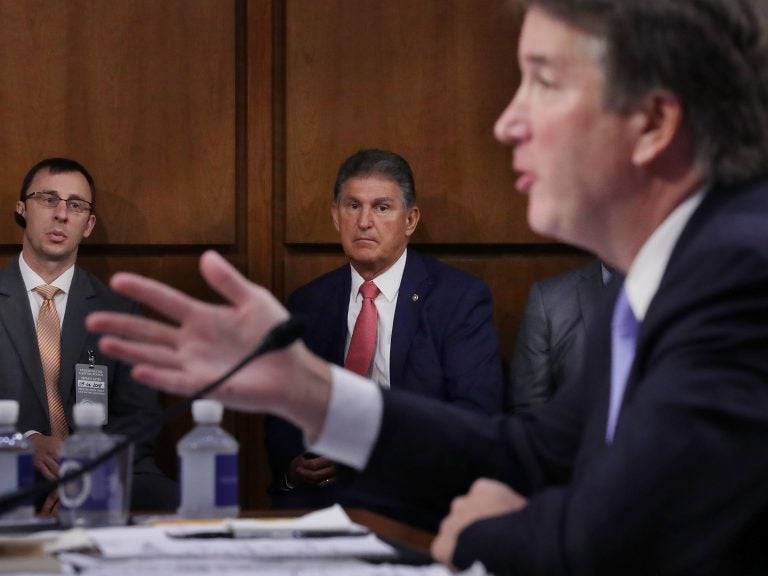 Sen. Joe Manchin, D-W.Va., listens to Supreme Court nominee Judge Brett Kavanaugh as he testifies before the Senate Judiciary Committee on Sept. 6. Running a tight reelection race in a conservative state, Manchin has faced pressure to support Kavanaugh.