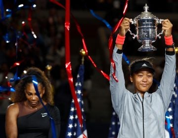 Naomi Osaka of Japan poses with the championship trophy after winning the Women's Singles finals match against Serena Williams at the 2018 U.S. Open. (Julian Finney/Getty Images)
