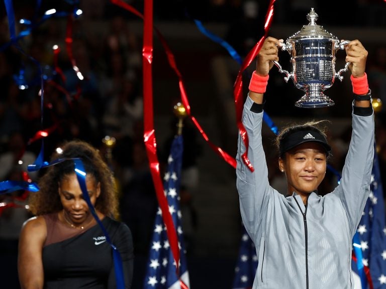 Naomi Osaka of Japan poses with the championship trophy after winning the Women's Singles finals match against Serena Williams at the 2018 U.S. Open. (Julian Finney/Getty Images)
