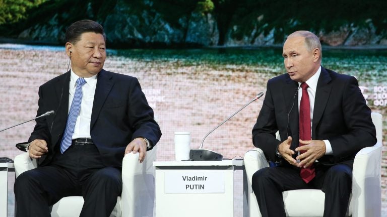 The U.S. is sanctioning China's military for buying equipment from Russia that included fighter jets and surface-to-air missiles. Russian President Vladimir Putin (right) is show with Chinese President Xi Jinping, in Russia earlier this month. (Bloomberg/Bloomberg via Getty Images)