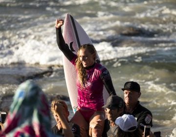 U.S. surfer Lakey Peterson is carried up the beach after claiming victory in a World Surf League event in Australia in March. The league says it will start paying the same prize money to men and women. (Jason Childs/Getty Images)