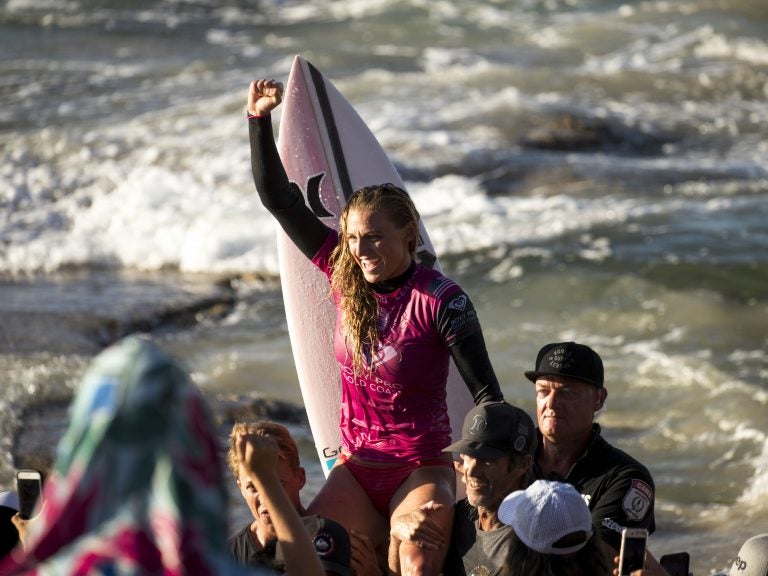 U.S. surfer Lakey Peterson is carried up the beach after claiming victory in a World Surf League event in Australia in March. The league says it will start paying the same prize money to men and women. (Jason Childs/Getty Images)