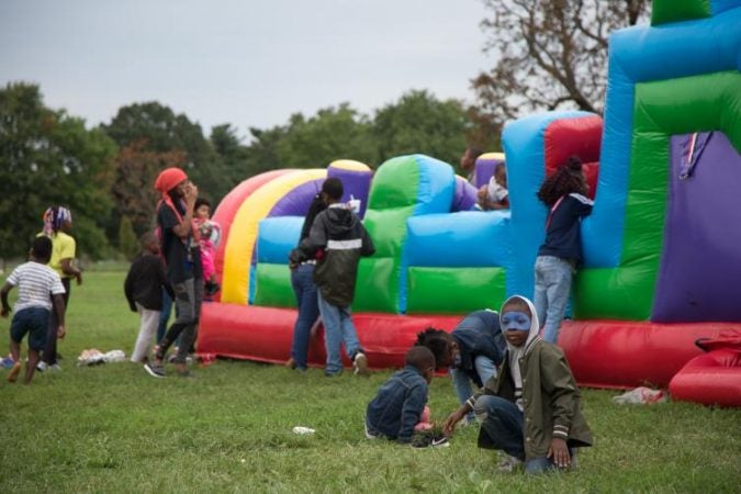 Kids play on a bouncy castle at Strawberry Mansion Day. (Emily Cohen for WHYY)