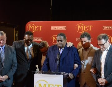 City officials and developers pray at Monday's announcement on the historic Met's reopening in Decemebr. (Tom MacDonald/WHYY)