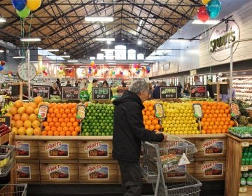 A shopper browses the produce at the new Sprouts market on South Broad Street. (Emma Lee/WHYY)