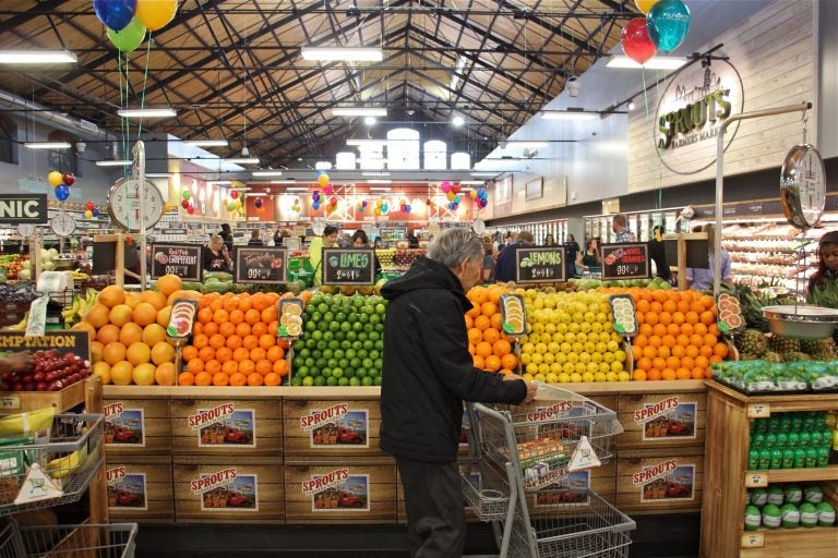 A shopper browses the produce at the new Sprouts market on South Broad Street. (Emma Lee/WHYY)