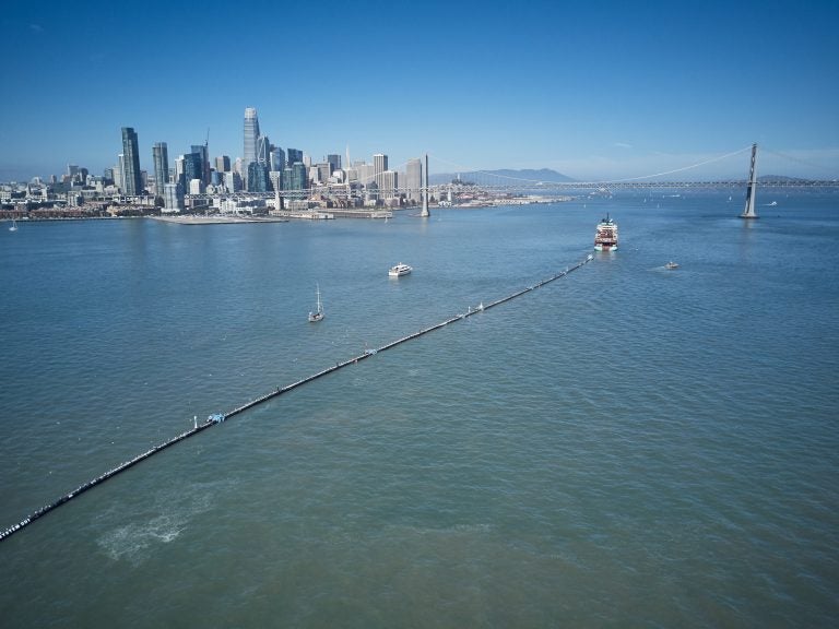 A nearly 2,000-foot-long tube is towed offshore from San Francisco Bay on Saturday. It's a giant garbage collector, and the brainchild of 24-year-old Boyan Slat, who aims to remove 90 percent of ocean plastic by 2040. (The Ocean Cleanup)