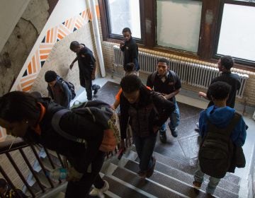 Students pass though a stairwell at Overbrook High School. (Emily Cohen for WHYY)