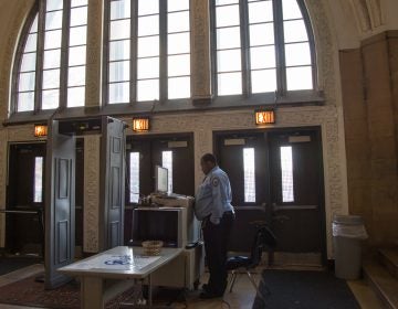 A metal detector and an x-ray machine sit at the entrance of Overbrook High School in Philadelphia. (Emily Cohen for WHYY, file)