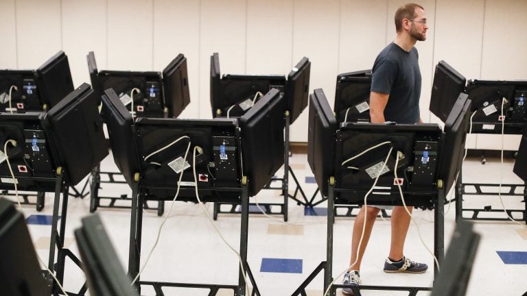 Voters cast their ballots in August among an array of electronic voting machines in a polling station at the Noor Islamic Cultural Center in Dublin, Ohio. The machines were manufactured by Elections Systems and Software, the largest manufacturer of voting equipment in the country. (John Minchillo/AP)