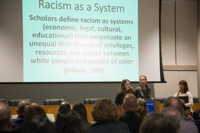 Members of H-CAN, Havertown Area Community Action Network, address residents gathered together at the new Haverford Township Building. They met for a town hall to address racism and racial bias in the Haverford Township school district. (Emily Cohen for WHYY)