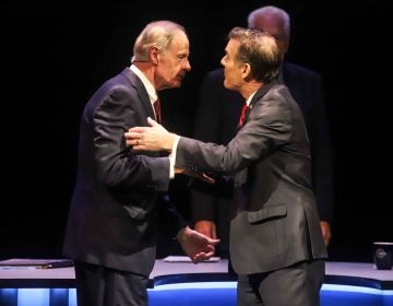 Incumbent Democrat U.S. Sen. Tom Carper (left) shakes hands with Republican challenger Rob Artlett prior to their debate that later grew contentious. Wednesday night. (Saquan Simpson for WHYY)