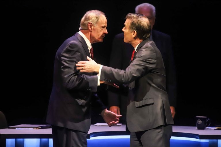 Incumbent Democrat U.S. Sen. Tom Carper (left) shakes hands with Republican challenger Rob Artlett prior to their debate that later grew contentious. Wednesday night. (Saquan Simpson for WHYY)