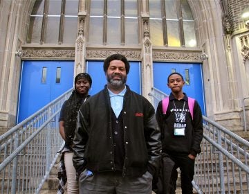 El-Mekki, then principal of Mastery Shoemaker Elementary in Philadelphia, pictured in front of the school with two students in 2018. (Emma Lee/WHYY)