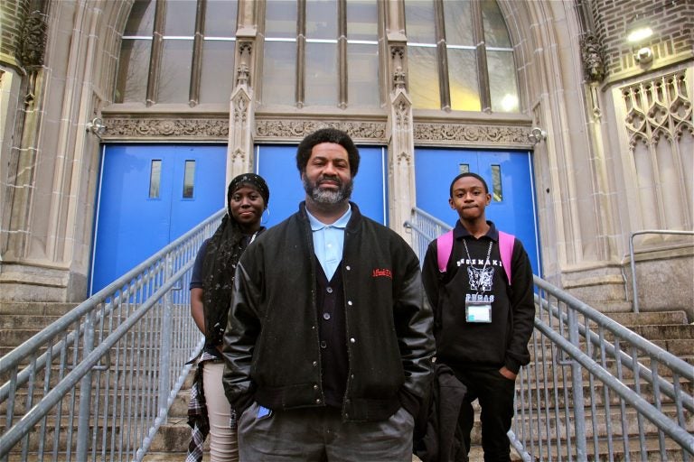 El-Mekki, then principal of Mastery Shoemaker Elementary in Philadelphia, pictured in front of the school with two students in 2018. (Emma Lee/WHYY)