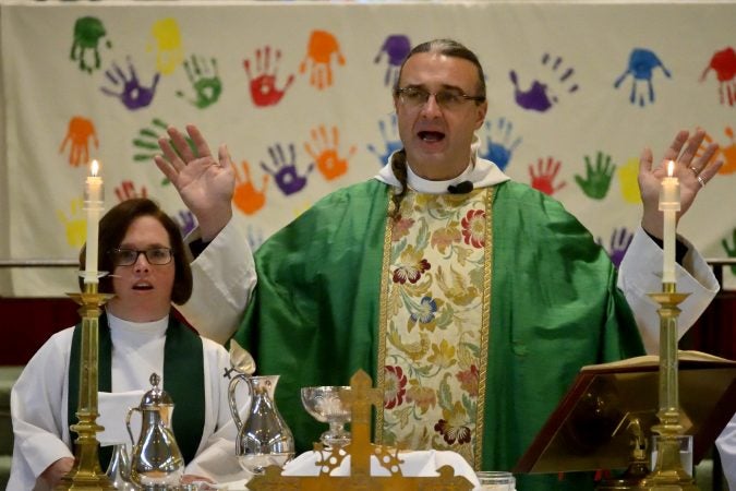 Rev. Canon Kirk Berlenbach serves as a guest celebrant and preacher, sided to the right by Rev. Emily Richards during mass at St. Peter's Episcopal Church. (Bastiaan Slabbers for Keystone Crossroads)