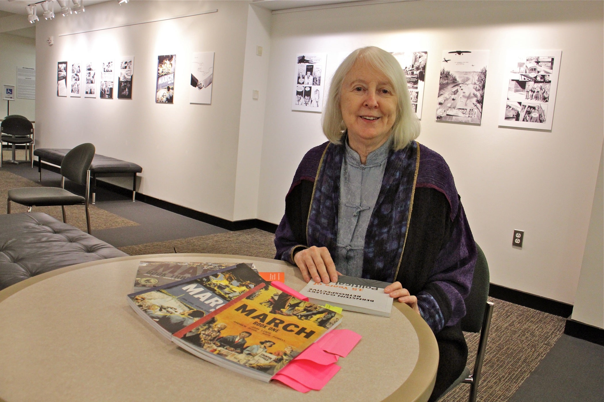 Mary Oestereicher Hamill, co-director of the Bernstein Gallery at Princeton University, lays out the graphic novels featured in the exhibit.