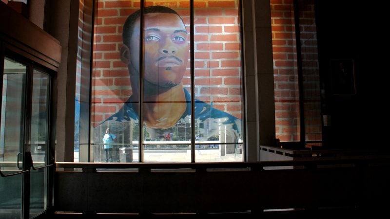The first floor of the Municipal Services Building is wrapped with the portraits of 17 formerly incarcerated young men and women as part of the Mural Arts 