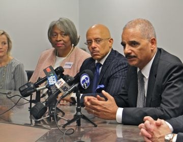 Former U.S. Attorney General Eric Holder (right) throws his weight behind six Democratic Pennsylvania Senate candidates he says will bring an end to partisan gerrymandering in the state. (Emma Lee/WHYY)