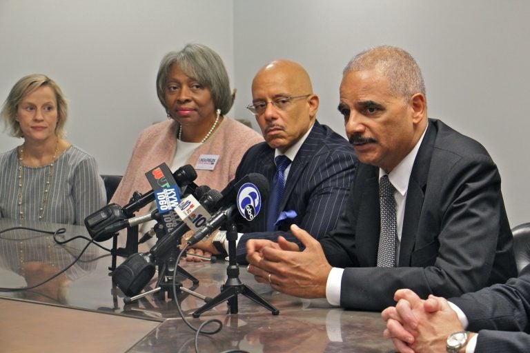 Former U.S. Attorney General Eric Holder (right) throws his weight behind six Democratic Pennsylvania Senate candidates he says will bring an end to partisan gerrymandering in the state. (Emma Lee/WHYY)