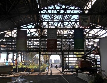 Workers prepare the Cherry Street Pier art and civic space for its grand opening Friday night, Oct. 12, 2018. (Emma Lee/WHYY)