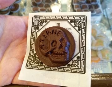 A traditional Victorian funeral biscuit, recreated as a chocolate medallion, is for sale at Shane Confectionery in Old City. (Peter Crimmins/WHYY)