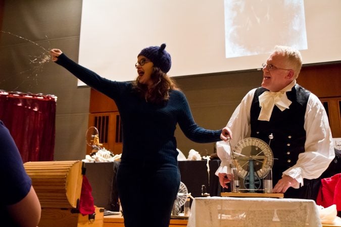 An audience member conveys an electrical charge at the History of Frankenstein show at the Science History Institute. (Kimberly Paynter/WHYY)