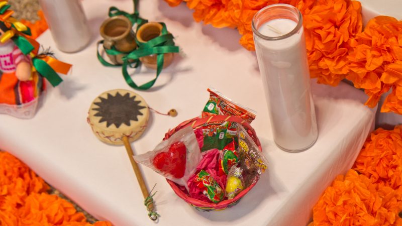 Candy and toys placed around the altar honor families that have lost children. (Kimberly Paynter/WHYY)