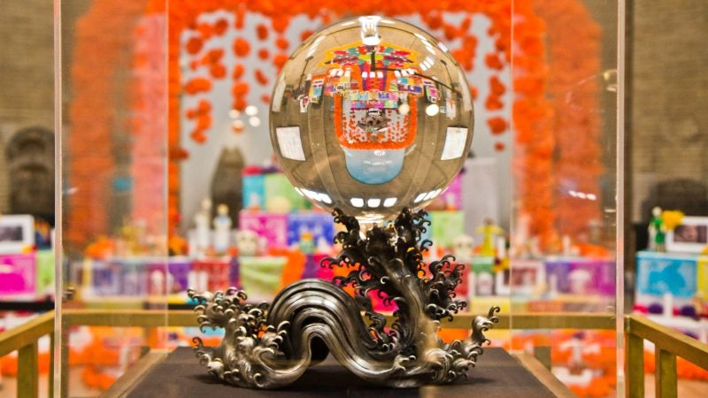The Day of the Dead altar is reflected in the Penn Museum’s crystal sphere. (Kimberly Paynter/WHYY)