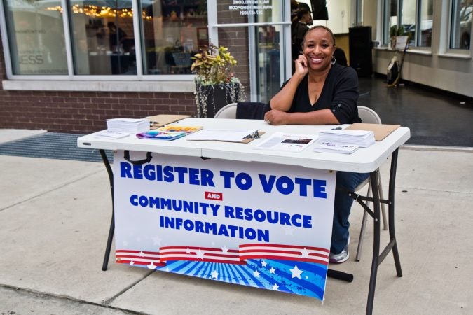 Annette Randolph works to register voters at the Point Breeze Night Market. (Kimberly Paynter/WHYY)