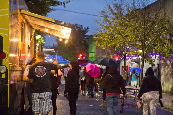 Rain doesn’t hold off the crowd at the Point Breeze Night Market. (Kimberly Paynter/WHYY)