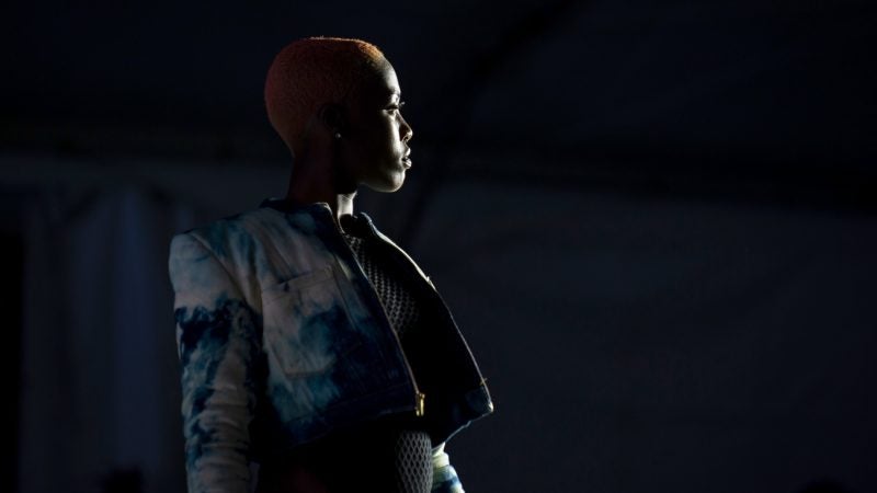 A model poses at the end of the runway during Philadelphia Fashion Week, held at Dilworth Park. (Kriston Jae Bethel for WHYY)