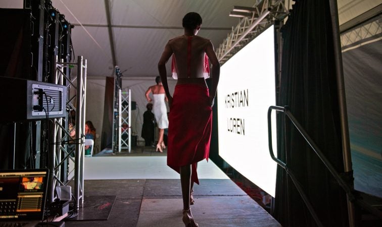 A model steps out to the runway at Philadelphia Fashion Week, held at Dilworth Park. (Kriston Jae Bethel for WHYY)