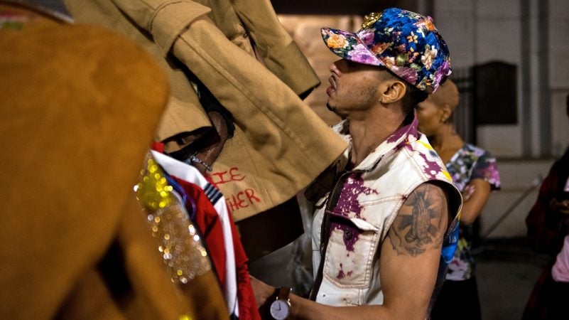 New York designer Check Fernandez preps his collection backstage at Philadelphia Fashion Week, held at Dilworth Park. (Kriston Jae Bethel for WHYY)