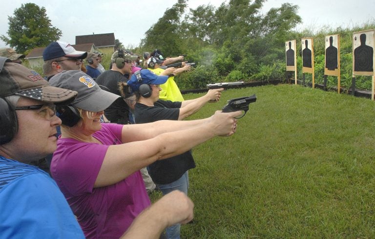 Educators fire off rounds during a concealed carry class for teachers Sunday, June 10, 2018, at  Adventure Tactical Training in Farmer City, Illinois. The class was designed to help teachers feel less vulnerable in the wake of a number of recent school shootings across the country.  (David Proeber, The Pantagraph via AP)