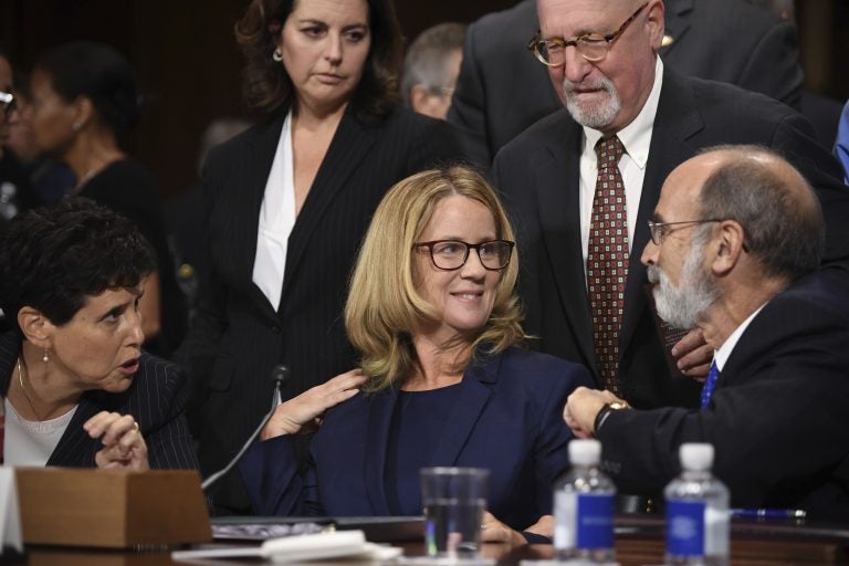 Christine Blasey Ford, the woman accusing Supreme Court nominee Brett Kavanaugh of sexually assaulting her at a party 36 years ago, chats with her attorneys as she testifies before the US Senate Judiciary Committee on Capitol Hill in Washington, DC, September 27, 2018. (Saul Loeb/Pool Photo via AP)