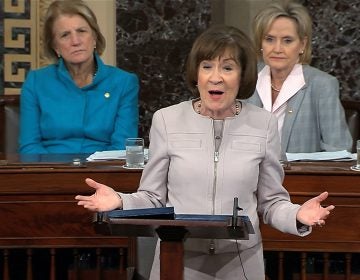 In this image from video provided by Senate TV, Sen. Susan Collins, R-Maine., speaks on the Senate floor about her vote on Supreme Court nominee Judge Brett Kananaugh, Friday, Oct. 5, 2018 in the Capitol in Washington.  Sen Shelly Capito, R-W.Va., sits rear left and Sen. Cindy Hyde-Smith, R-Miss., sits right.  (Senate TV via AP)