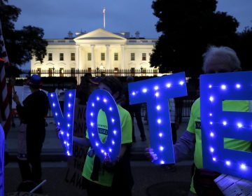 Sharon Canner, 75, and her husband Steve Canner, 81, of Reston, Va., hold up letters spelling 