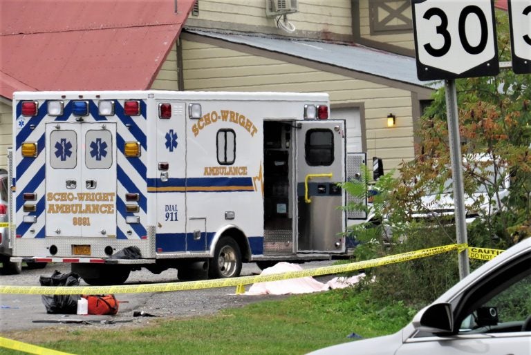 In this Saturday, Oct. 6, 2018 photo, a body is draped under a blanket at the scene of a fatal crash in Schoharie, N.Y. (Tom Heffernan Sr. via AP)