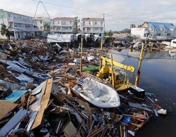 FILE - In this Oct. 11, 2018 file photo, a boat sits amidst debris in the aftermath of Hurricane Michael in Mexico Beach, Fla. Hurricane Michael has shown that President Donald Trump can’t be counted on to give accurate information to the public when a natural disaster unfolds. (AP Photo/Gerald Herbert, File)