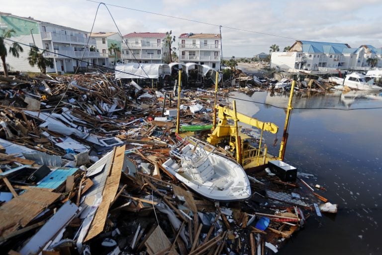 FILE - In this Oct. 11, 2018 file photo, a boat sits amidst debris in the aftermath of Hurricane Michael in Mexico Beach, Fla. Hurricane Michael has shown that President Donald Trump can’t be counted on to give accurate information to the public when a natural disaster unfolds. (AP Photo/Gerald Herbert, File)