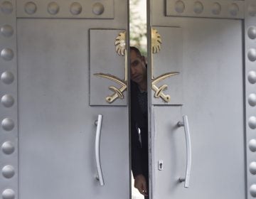 A security personnel looks out from the entrance of the Saudi Arabia's consulate in Istanbul, Sunday, Oct. 14, 2018. Writer Jamal Khashoggi, vanished after he walked into the consulate on Oct. 2. (AP Photo/Petros Giannakouris)