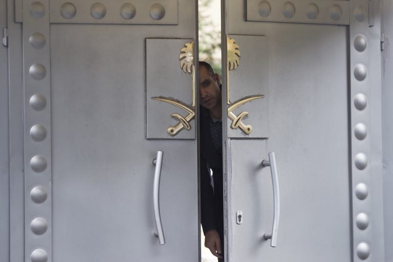 A security personnel looks out from the entrance of the Saudi Arabia's consulate in Istanbul, Sunday, Oct. 14, 2018. Writer Jamal Khashoggi, vanished after he walked into the consulate on Oct. 2. (AP Photo/Petros Giannakouris)