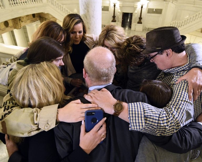 Survivors of child sexual abuse hug in the Pennsylvania Capitol while awaiting legislation to respond to a landmark state grand jury report on child sexual abuse in the Roman Catholic Church, Wednesday, in Harrisburg. (AP Photo/Marc Levy)
