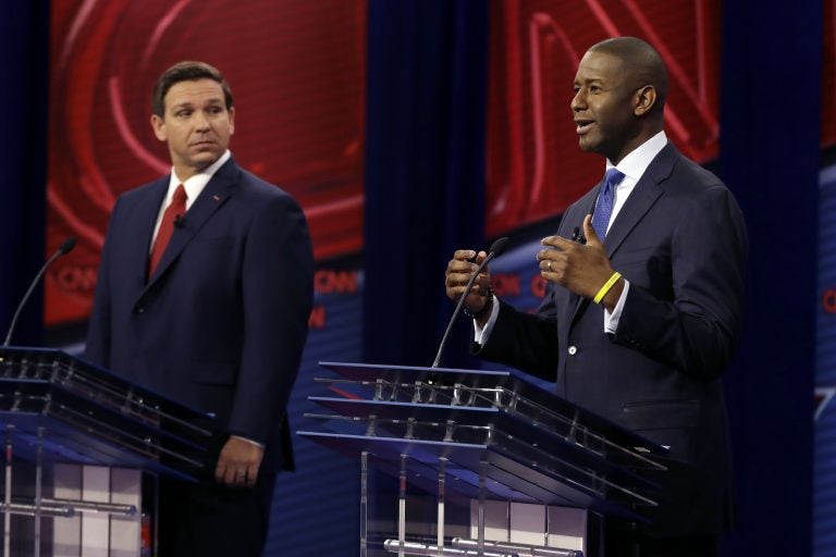 Florida Democratic gubernatorial candidate Andrew Gillum, right, speaks as Republican gubernatorial candidate Ron DeSantis looks on during a CNN debate, Sunday, Oct. 21, 2018, in Tampa, Fla. (AP Photo/Chris O'Meara)