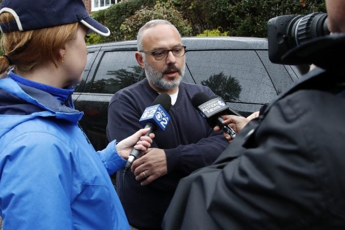 Jeff Finkelstein, (center), president and CEO of the Jewish Federation of Greater Pittsburgh, is interviewed several blocks from the Tree of Life Synagogue where a shooter opened fire Saturday, Oct. 27, 2018, wounding multiple police officers and causing 