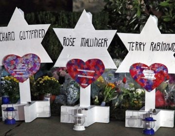 This photo shows some of Stars of David with names of those killed at the Tree of Life Synagogue in Pittsburgh in Saturday's shooting, at a memorial outside the synagogue. (AP Photo/Gene J. Puskar)