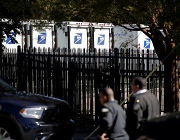 Law enforcement officials gather outside a U.S. post office facility after reports that a suspicious package was found in Atlanta, Monday, Oct. 29, 2018. (AP Photo/David Goldman)